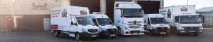 The full range of Gus Commercials' van and truck rental range lined up outside the company's workshop in Mallusk, including a Mercedes Sprinter van, a refrigerated Mercedes Sprinter van, a 3.5 tonne box body, an 18 tonne box body and a Mercedes Actros truck cab