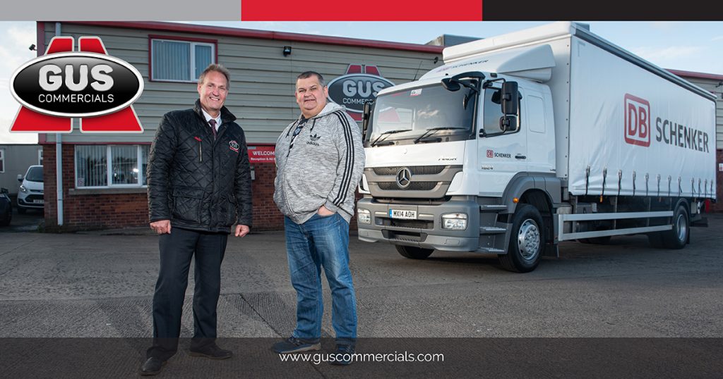 Owner Operator for DB Schenker in Mallusk, Hugh Burns, accepting delivery of a truck from Eric Magill of Gus Commercials